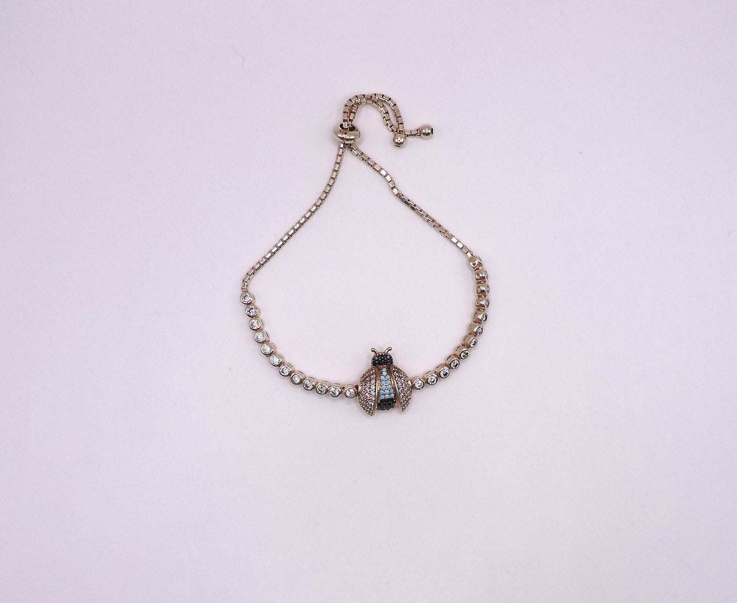 Rose gold silver bracelet with a Lady bag and zircons