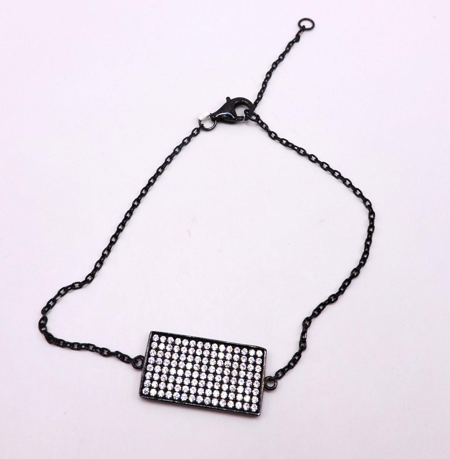 Black square silver bracelet with zircons.