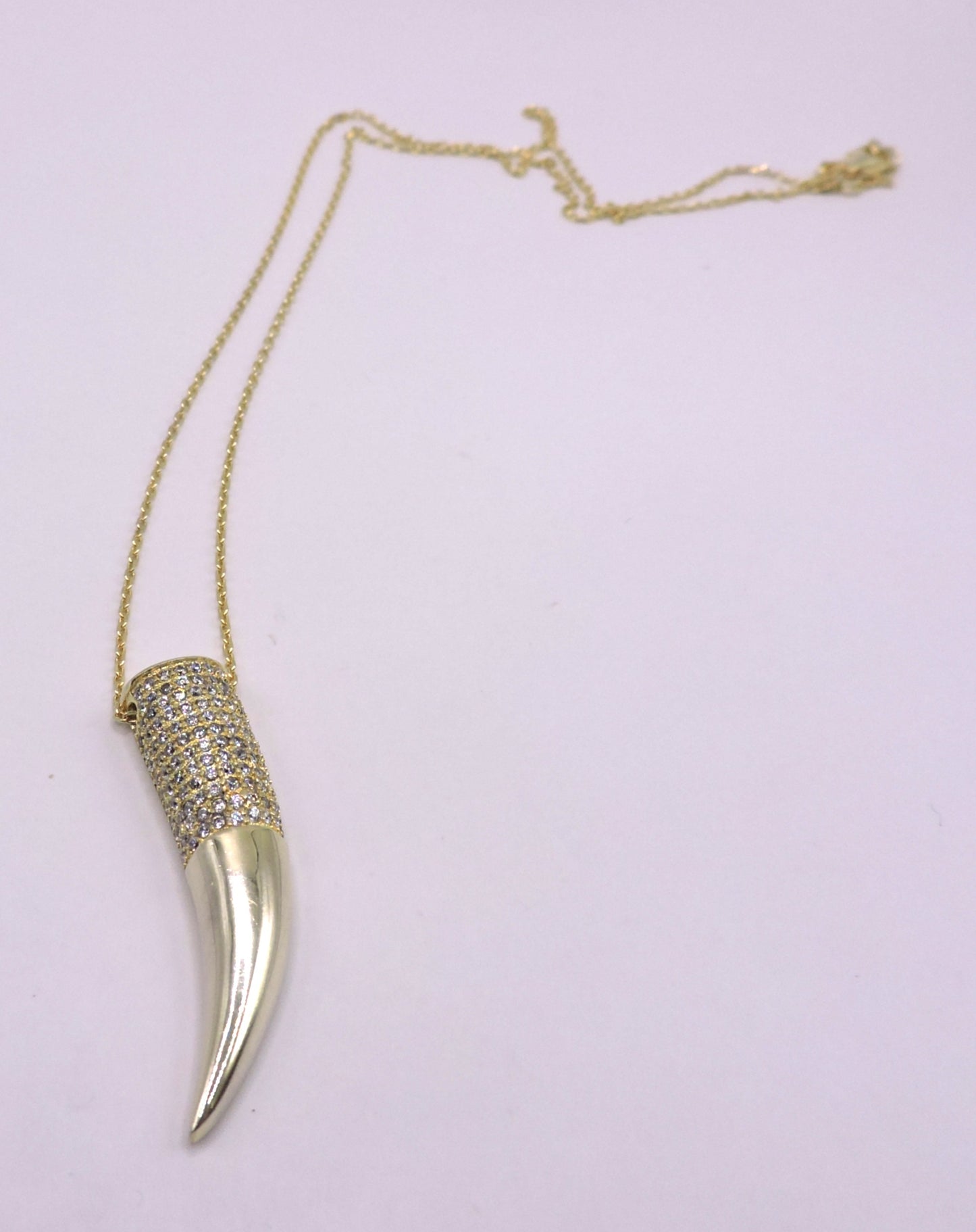 Gold-plated silver necklace with a horn-shaped pendant and zircons