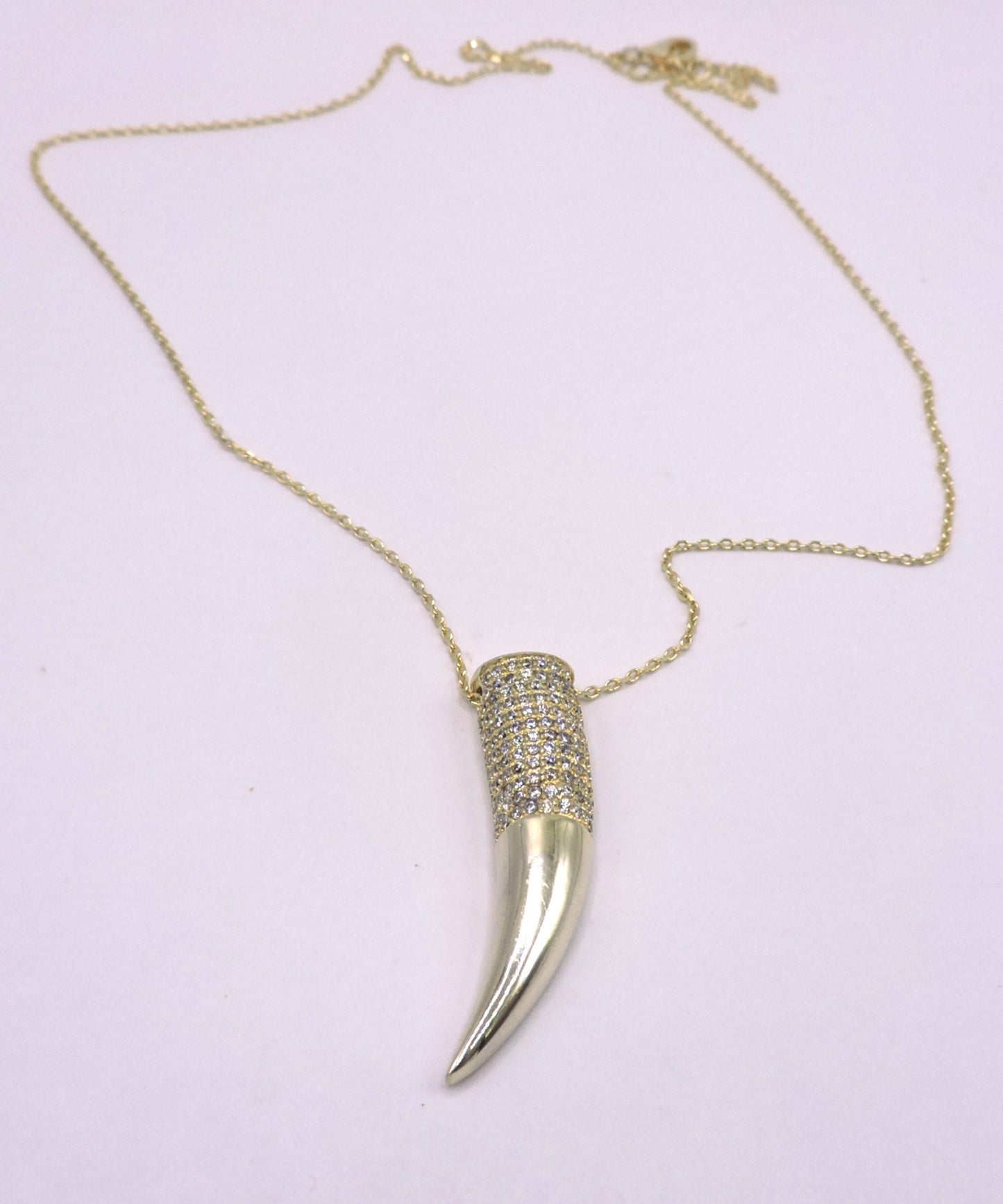 Gold-plated silver necklace with a horn-shaped pendant and zircons