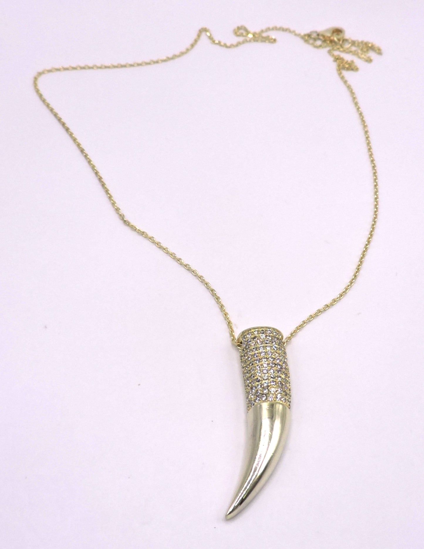 Gold-plated silver necklace with a horn-shaped pendant and zircons