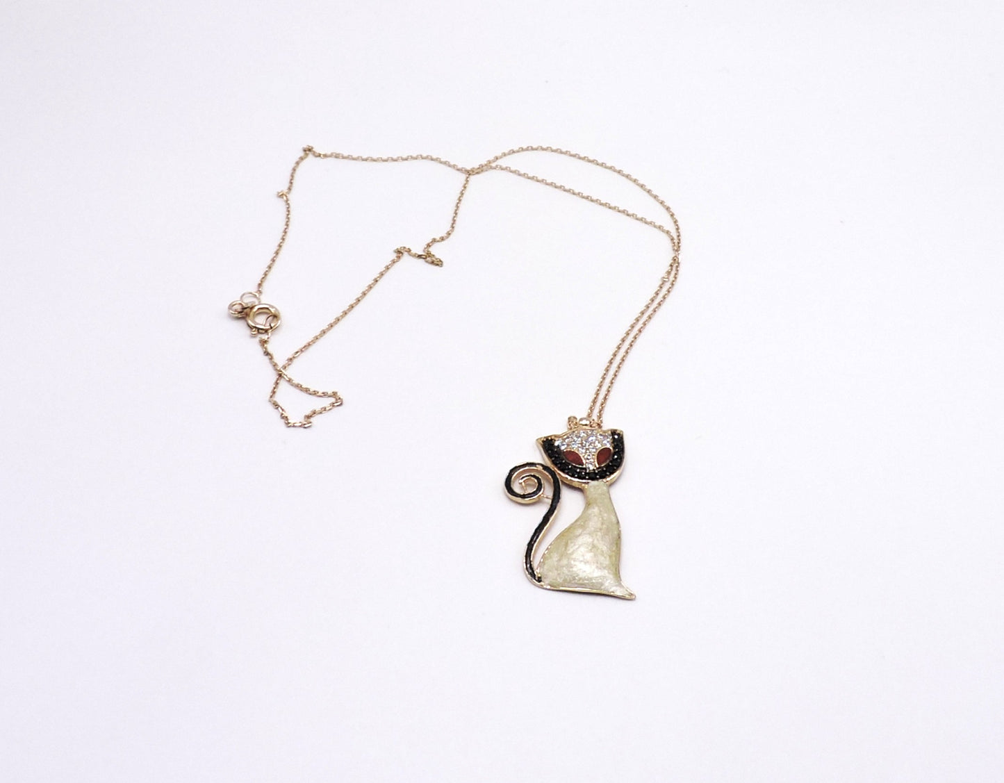 Rose gold-colored silver necklace in the shape of a cat with micropave enamel.