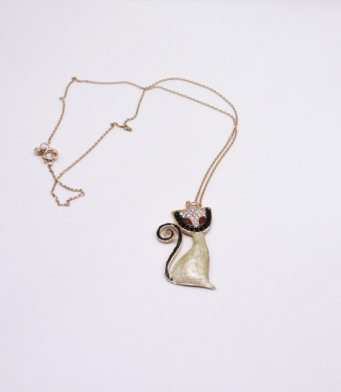 Rose gold-colored silver necklace in the shape of a cat with micropave enamel.