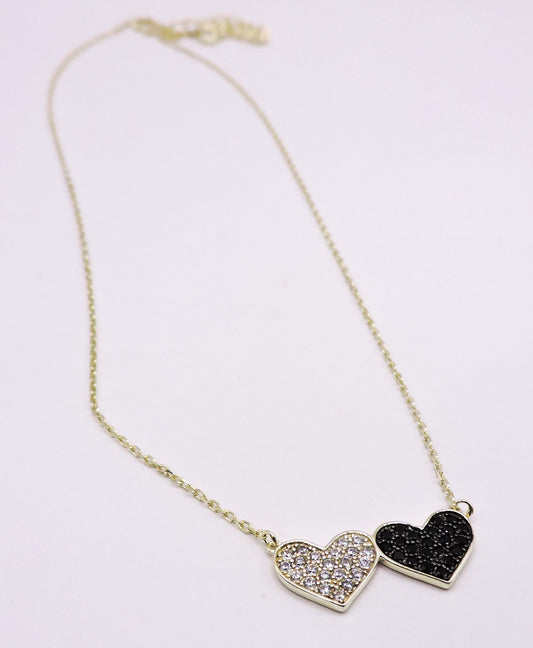 Silver necklace with black and white zircons, in the shape of a double heart