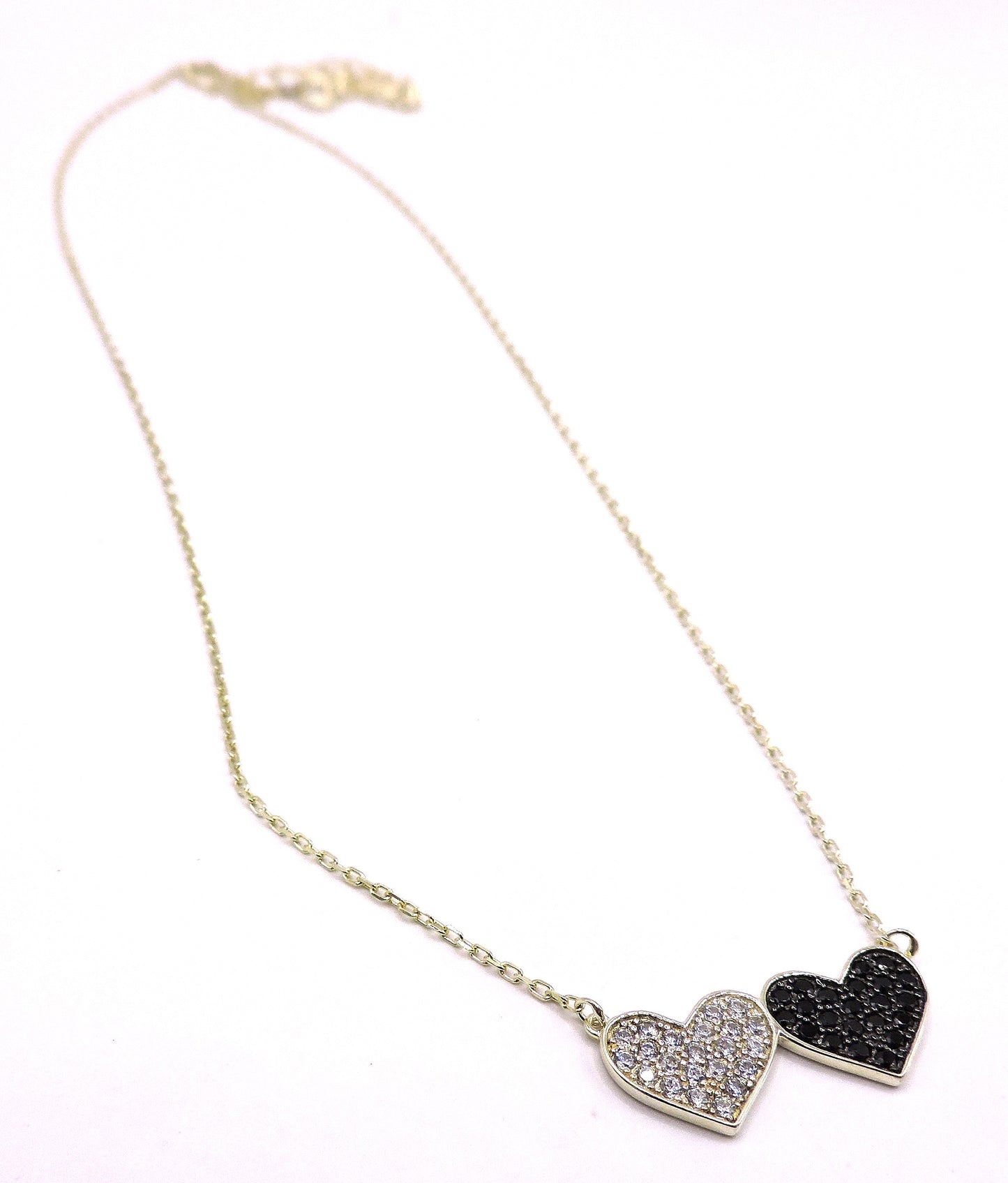Silver necklace with black and white zircons, in the shape of a double heart