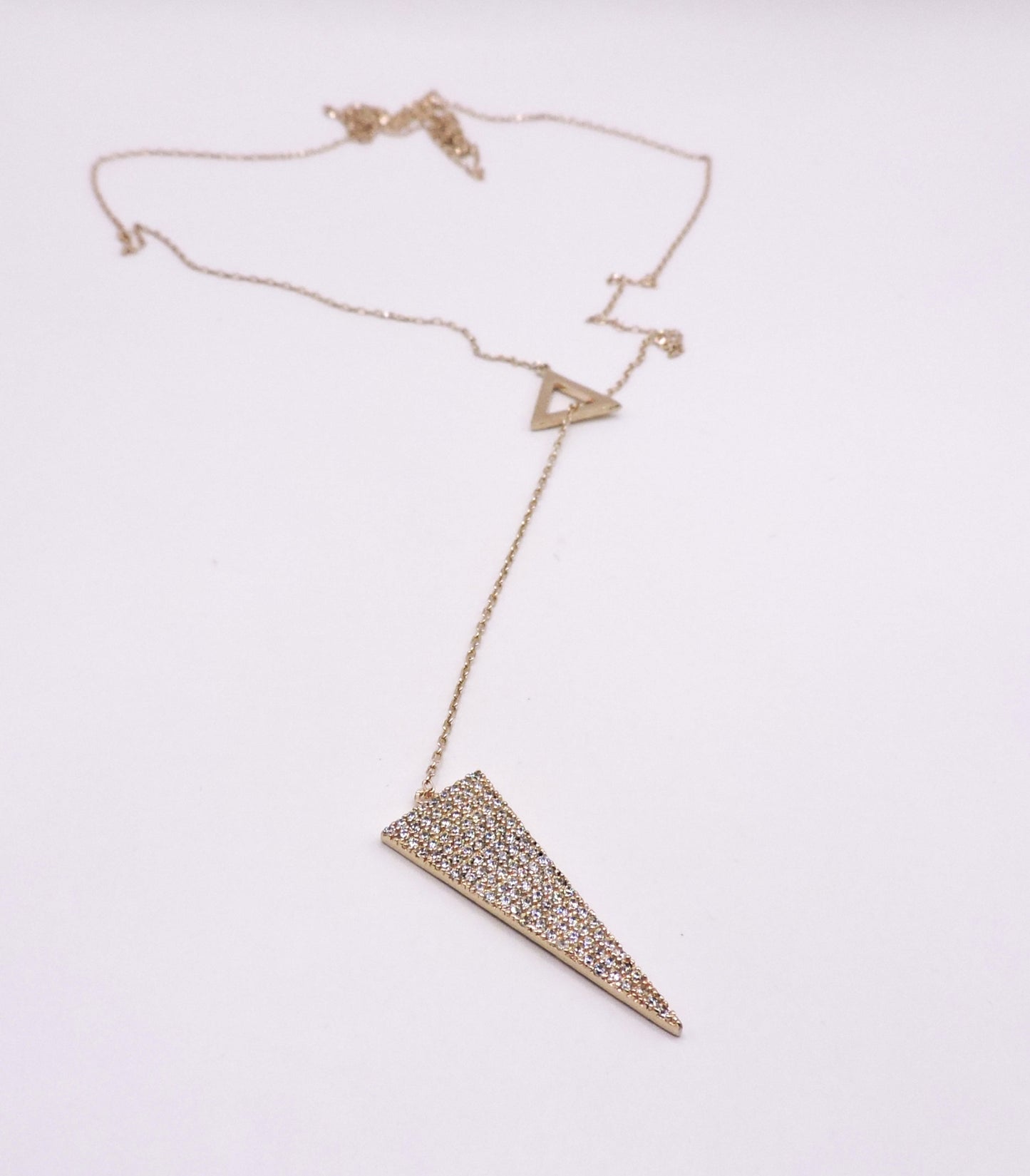 Rose gold silver necklace in the shape of an arrowhead, passed through a triangle.