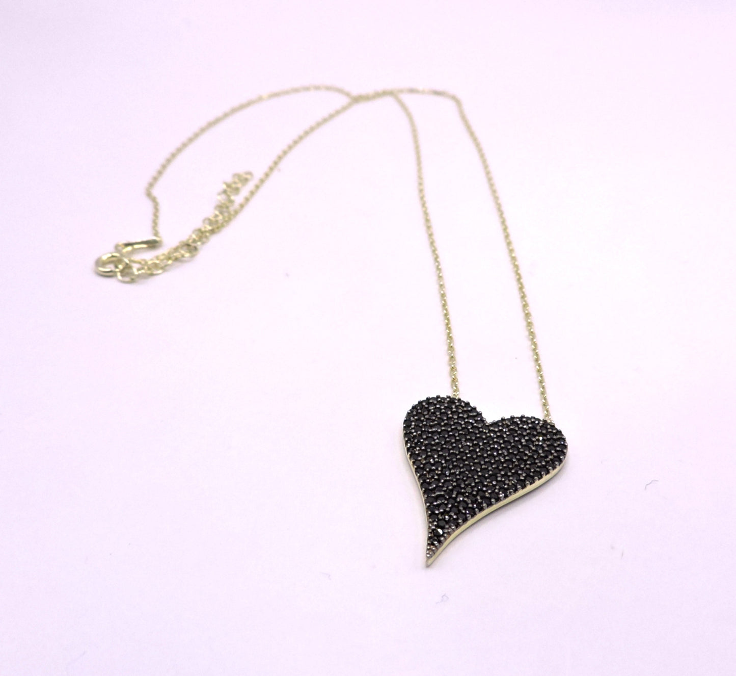 Gold-plated silver necklace, heart-shaped with black zircons.