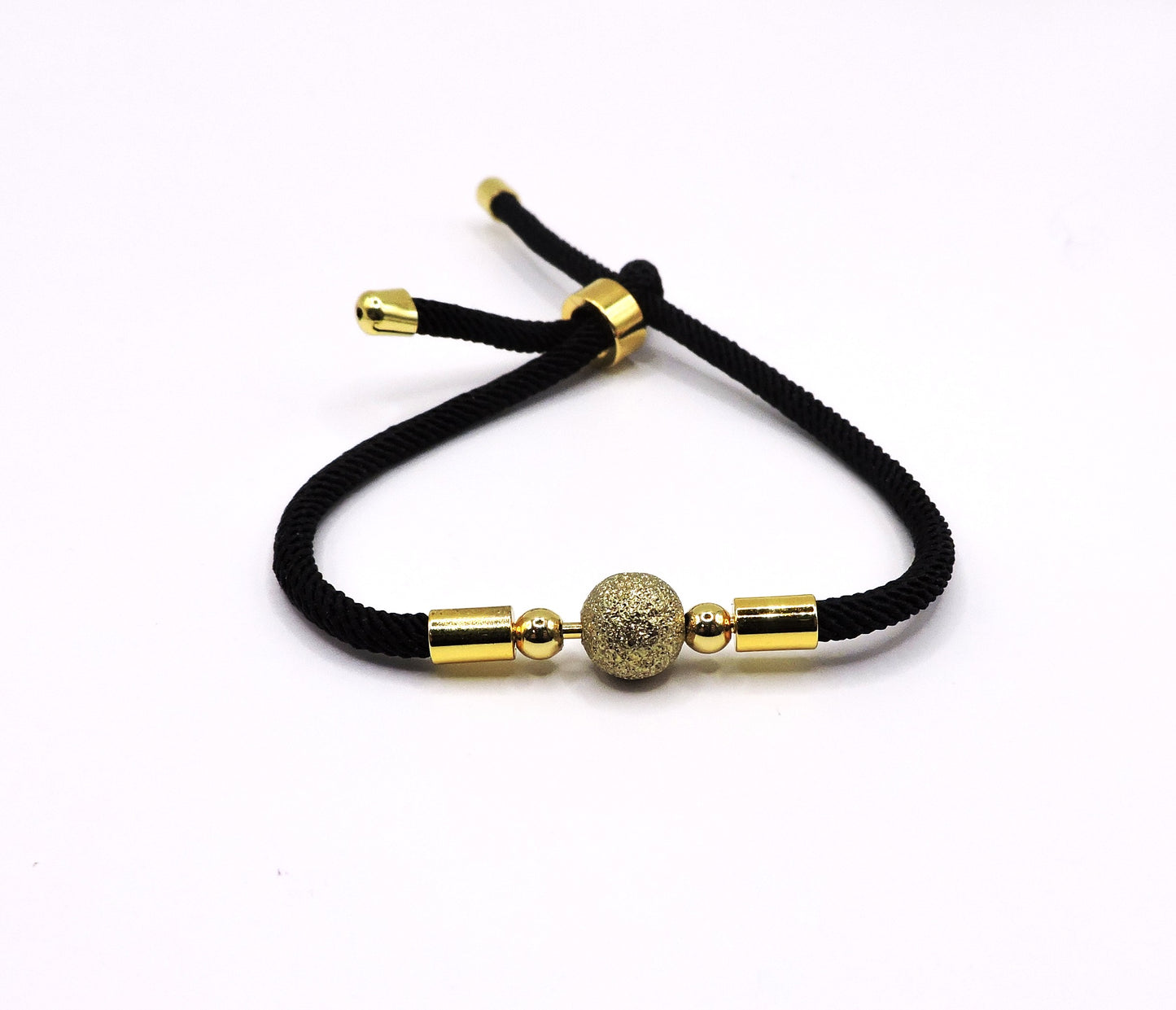 Adjustable cord bracelet with a golden ball