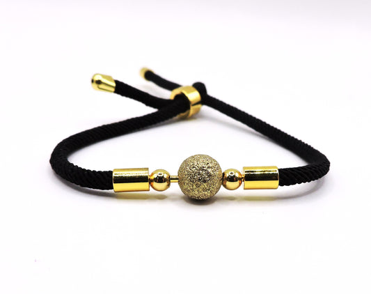 Adjustable cord bracelet with a golden ball